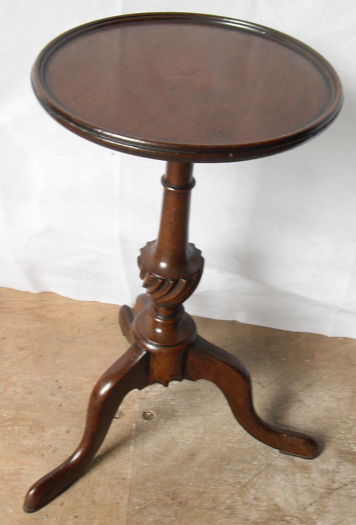 A George IV mahogany wine table with circular top, carved support on tripod base, 16 cm diameter