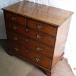 A 19th century oak-stained chest of two short and three long graduated drawers with quarter veneered