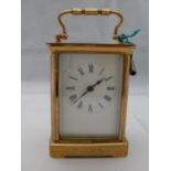 A French brass 8-day carriage clock by R & Co, Paris the fully glazed cornice case surmounted by a