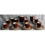 A Poole Pottery tea service comprising eight cups, eight saucers, six plates, sugar bowl, jug and