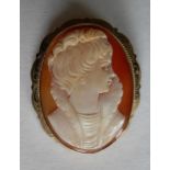 An oval shell cameo brooch depicting head and shoulders of a lady with applied rope decoration to