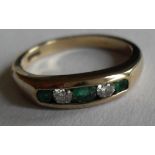 A diamond and emerald half-hoop ring set with two brilliant-cut diamonds alternating with three