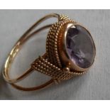 A stone set dress ring comprising an oval mixed-cut synthetic corundum, imitating alexandrite,
