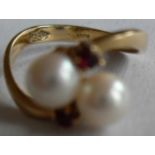 A stone set dress ring comprising two half-drilled akoya cultured pearl beads measuring 5.4mm