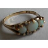 An opal and diamond set ring comprising three circular cabochon-cut white opals (5.5mm, 4.2mm, 4.2mm