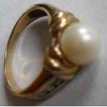 A cultured pearl and diamond dress ring centrally set with a cultured pearl bead, measuring approx