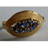 A cluster ring set with eight round mixed-cut synthetic blue spinels measuring approx 1.6mm,