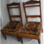 A pair of late Victorian walnut bedroom or occasional chairs with carved top rails, ladder supports,