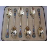 George V six-silver gilt and blue enamel coffee spoons in original fitted case, by Barker Brothers