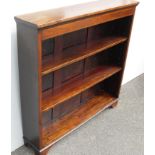 An Edwardian mahogany free-standing bookcase with moulded top, string inlay to frieze, two