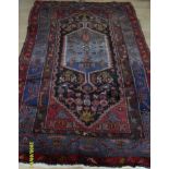 A Persian hand-knotted burgundy-ground Hamadan wool rug with multicoloured isometric designs, double