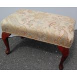 A Victorian-style oblong footstool with fabric upholstery raised on cabriole legs, 33 x 54 x 33 cm