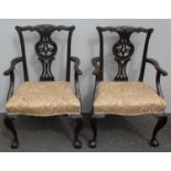 A pair of 19th century Chippendale-style carvers with carved top rails, arm supports, elaborate