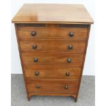 An Edwardian mahogany tall chest of five graduated drawers with turned handles, carved frieze,