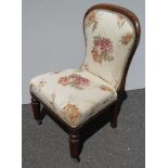 A recently re-upholstered adapted early Victorian occasional chair with carved oak top rail,