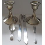 A pair of Birmingham silver dwarf candlesticks (with dents), 1923, a continental silver letter