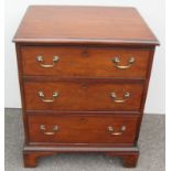 A Georgian chest of three graduated drawers with moulded top, brass drop handles and escutcheons