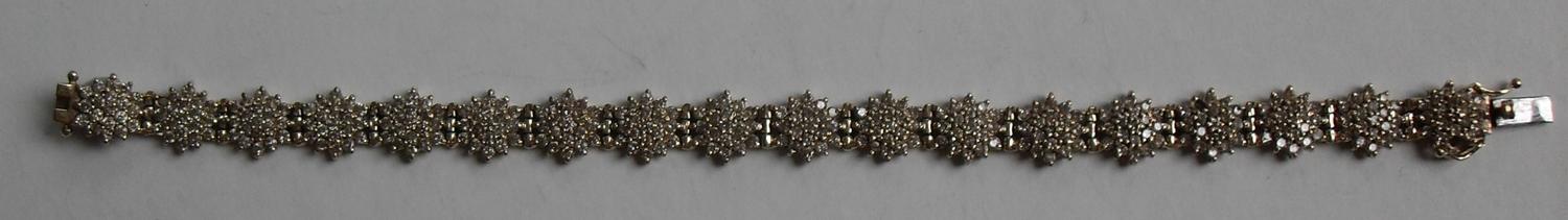 A gold and diamond bracelet comprising eighteen clusters of nineteen brilliant cut diamonds, ( - Image 5 of 5