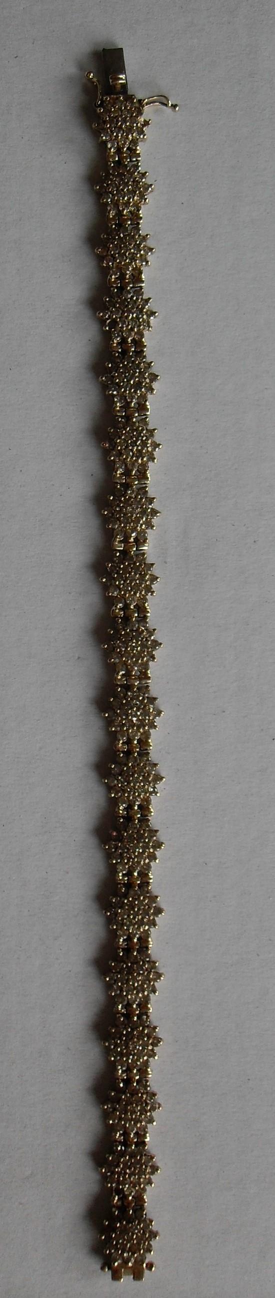 A gold and diamond bracelet comprising eighteen clusters of nineteen brilliant cut diamonds, ( - Image 2 of 5