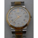 A Baume & Mercier Geneve Quartz gent's bracelet watch with black Roman numerals and yellow gold