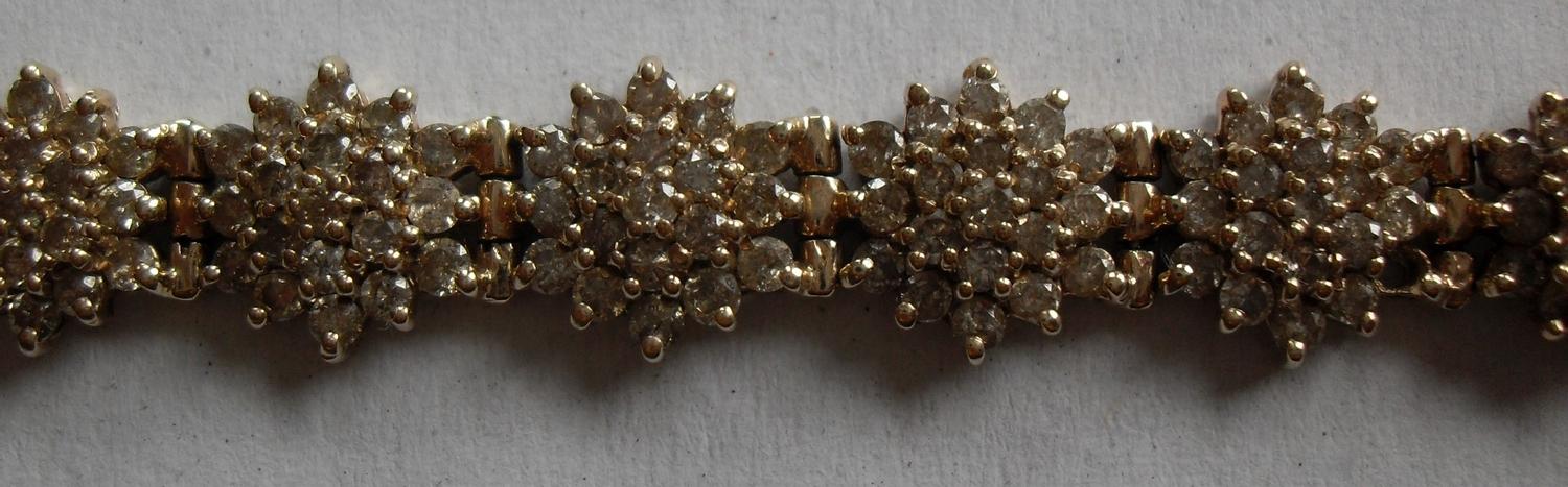 A gold and diamond bracelet comprising eighteen clusters of nineteen brilliant cut diamonds, ( - Image 3 of 5