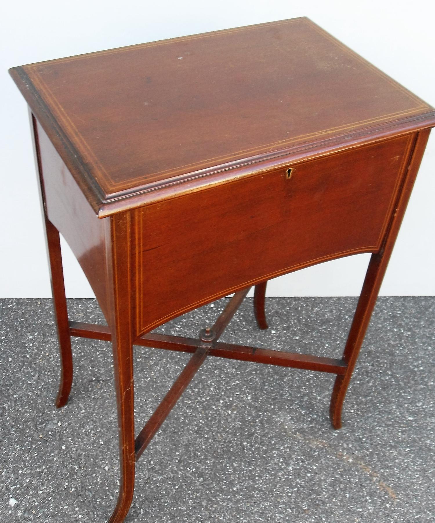 An Edwardian mahogany lady's work table with overall string inlay, hinged lid , fitted interior on
