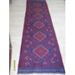 An Eastern hand-knotted Meshwani blue-ground wool runner with isometric depictions and short fringe,