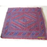 A Tajikistan hand-knotted tribal Gazak burgundy-ground rug with blue and yellow diagonal designs,