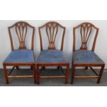 Three mahogany-framed Hepplewhite-style dining chairs with shield-back supports, fabric