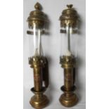 A pair of pierced brass and copper vintage-style wall sconces fitted with candle holders and