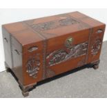 A late 19th / early 20th century Chinese camphor wood storage chest with carved designs to top and