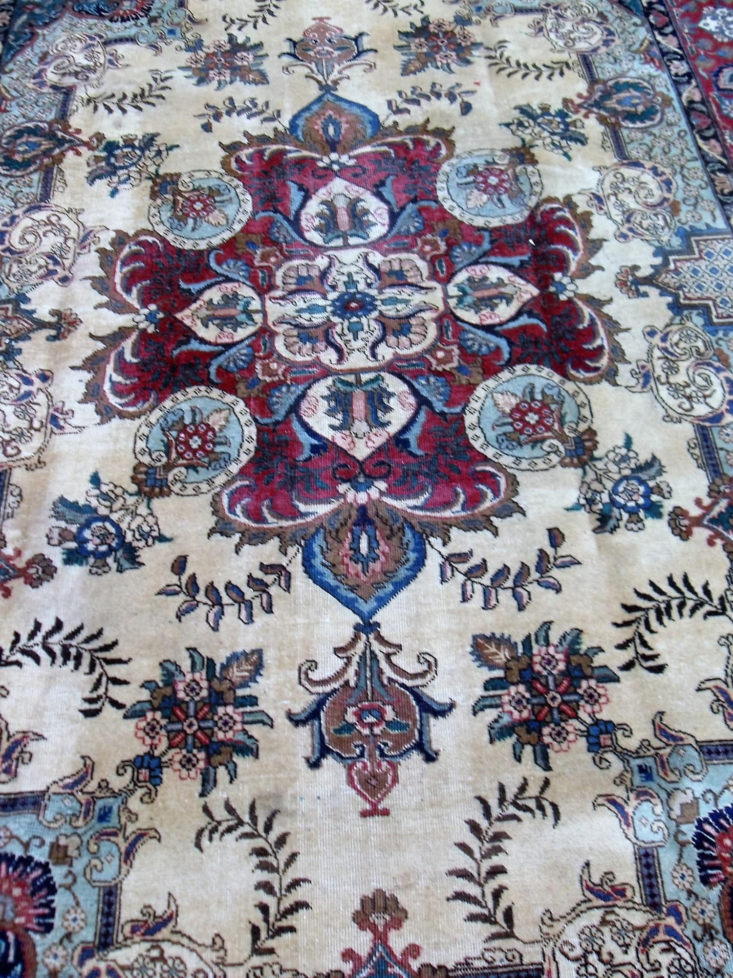 A Tabriz hand-knotted ivory-ground wool rug with multi-coloured floral and foliate designs, burgundy - Image 2 of 3