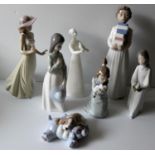 An assortment of two Lladro figurines, four Nao and one Royal Doulton of girls, ladies and