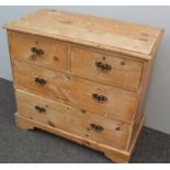 A 19th century pine chest of two long and two short drawers with brass drop handles on bracket feet,