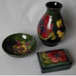 A Moorcroft baluster vase, 19.5 cm H, a circular bowl 14.5 cm diameter and an oblong lidded dish (