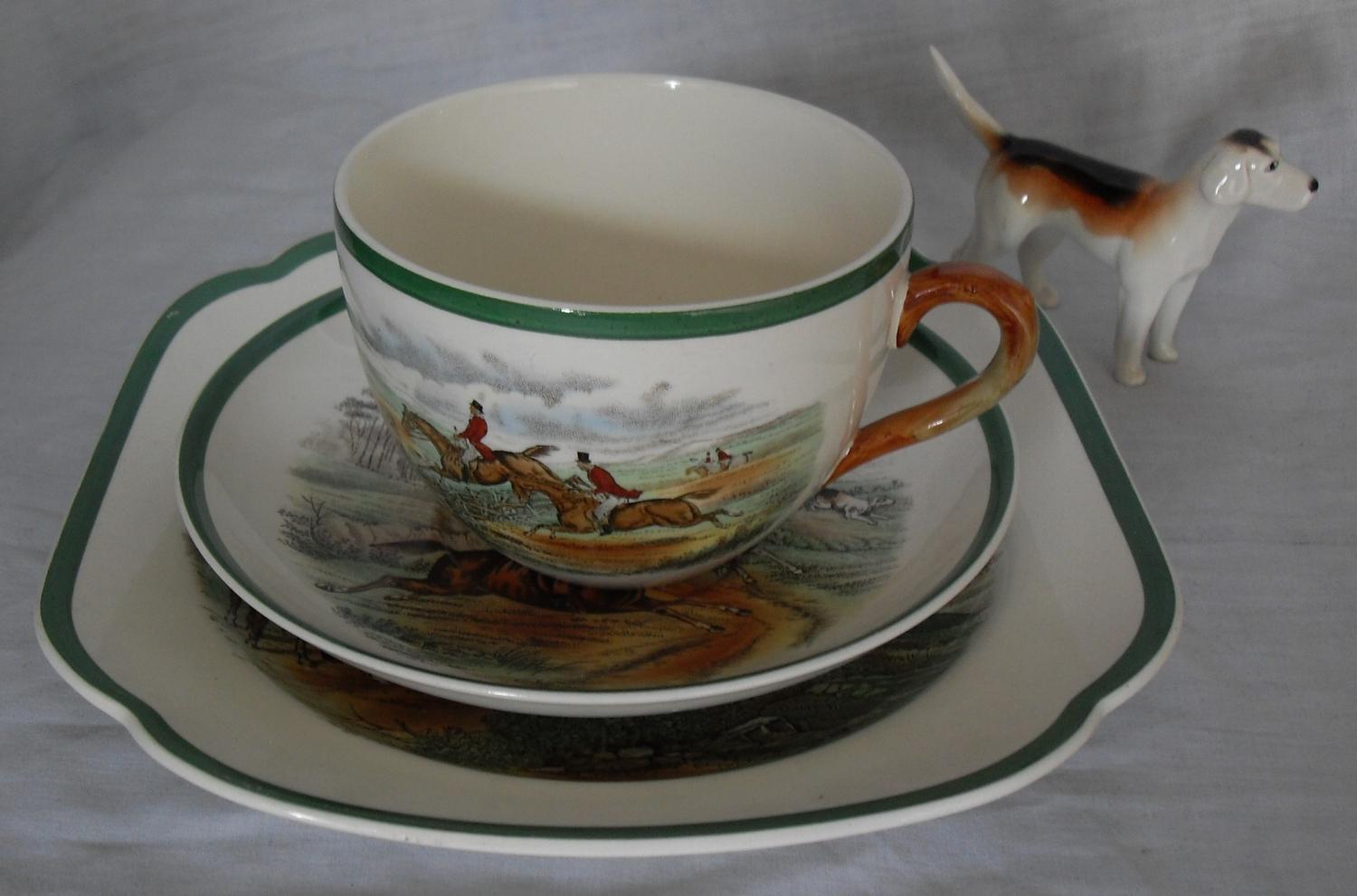 A Copeland Spode cup 'First Over', saucer 'Full Cry' and plate 'The Meet' with a Beswick beagle (4)