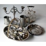 An assortment of silver plated items to include a two-branch table candelabra, four-bottle cruet set