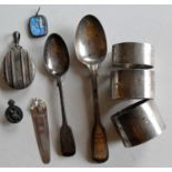 Three silver napkin rings and two tea spoons, all mixed dates and monogrammed; an Edwardian silver