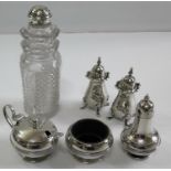 A six-piece silver cruet set. The pear-shape salt & pepper by E. S. Barnsely, Birmingham 1916 with