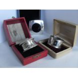 Three boxed silver napkin rings; Birmingham 1911, 1990 and Sheffield 2002 (3)