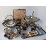 A selection of silver plated items to include three swing-handle baskets, tea service, cased fish