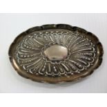 A Victorian silver oval pin tray with embossed decoration, London 1898, a Victorian silver brush set