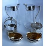 A pair of silver plate and glass wine servers, a pair of silver plated gilt salts and three plated