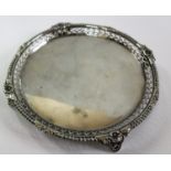 A George V circular silver salver with pierced gallery decoration on four feet by Edward Barnard &