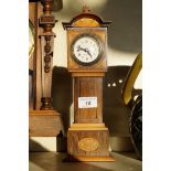 An Edwardian inlaid mantel clock, in the form of a