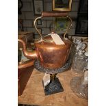 A Victorian copper kettle with a button finial and