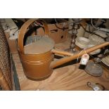 An Antique copper and brass banded watering can.