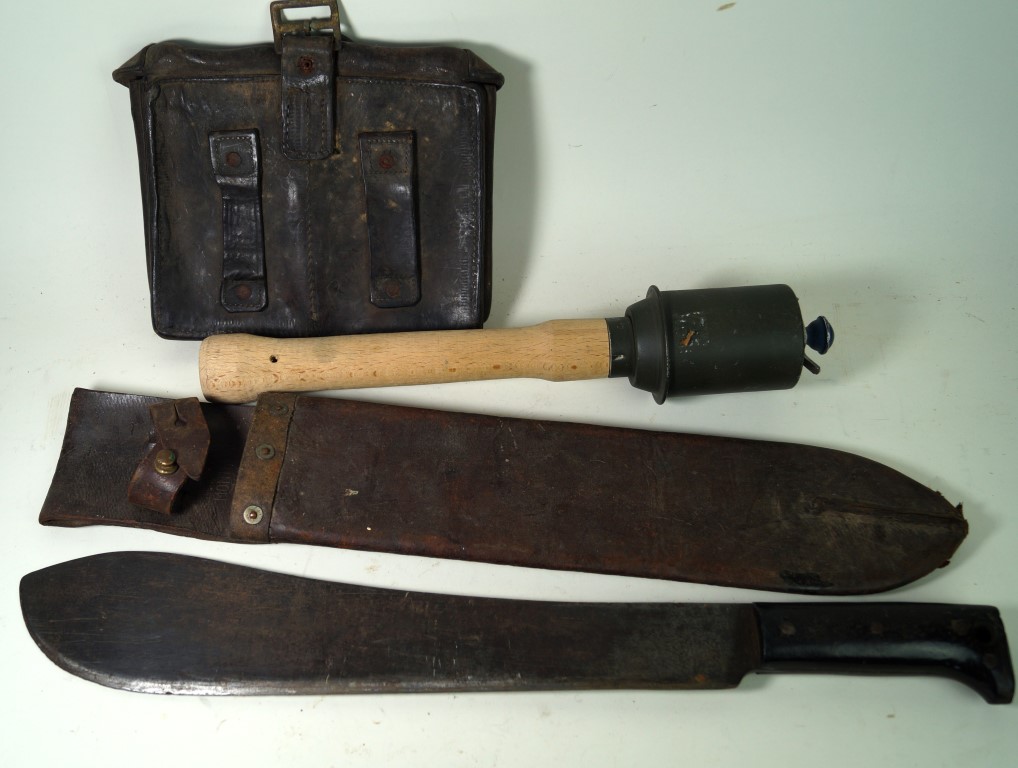 An American Legitimus machete dated 1943, complete with scabbard German stick grenade,