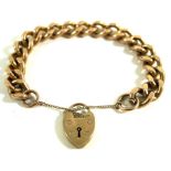 A 9ct gold curb link bracelet With a heart padlock and safety chain attached, weight 56.