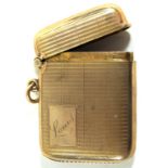 A 9ct gold vesta case Profusely engraved with engine turned decoration,